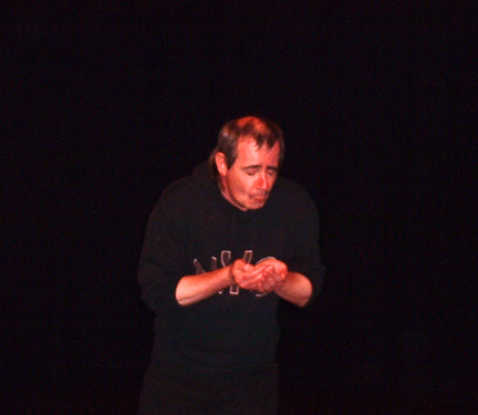 a picture of Chik performing on stage at the Paisley Arts Centre